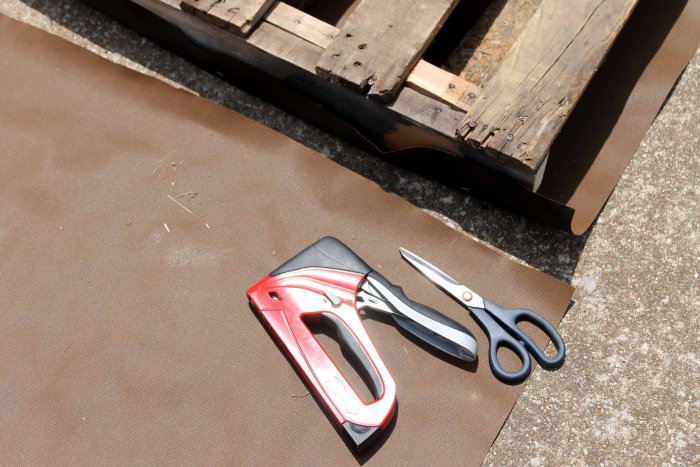 Cut your landscaping fabric to size and staple it onto the pallet. (Photo courtesy of Angie Holden/The Country Chic Cottage)